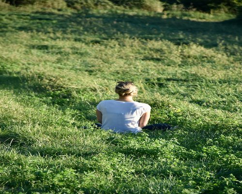 woman relaxing by looking at green nature